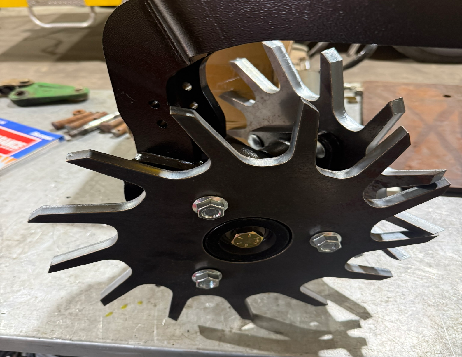Agricultural machinery component with spiked wheel.