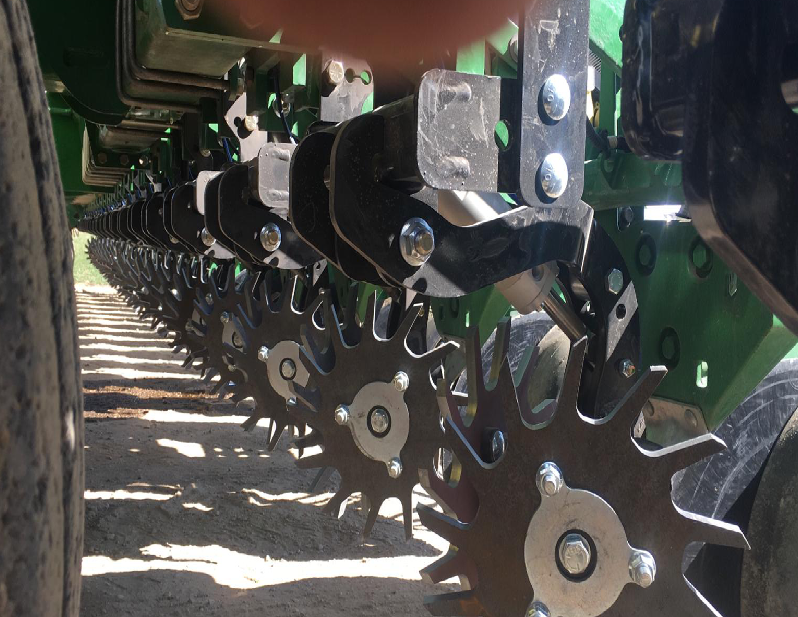 Close-up of agricultural machinery with gears.