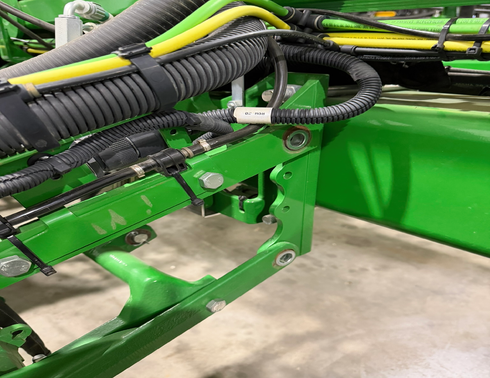 Green machinery with cables and connectors visible.