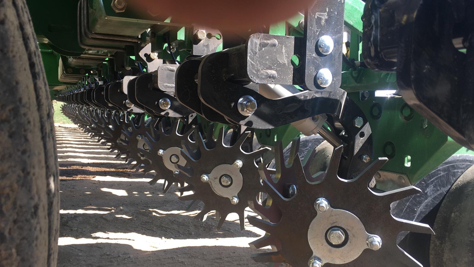 Agricultural machinery with metal spiked wheels.