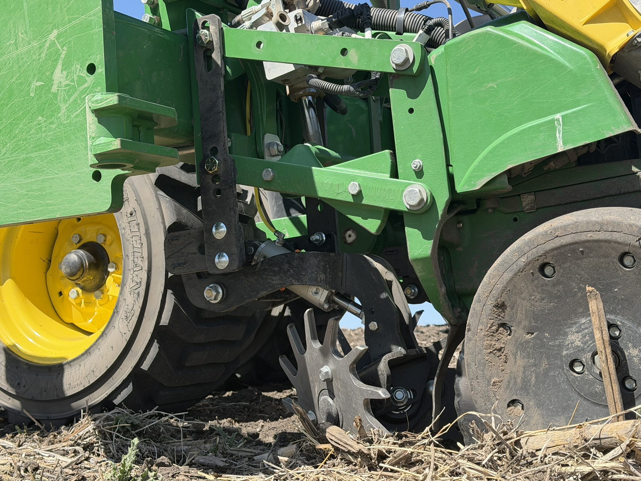 Green agricultural machinery on a field.