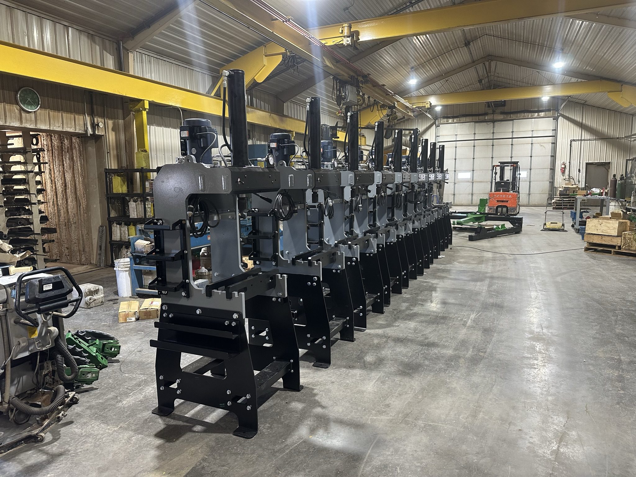 Row of industrial machines in a warehouse.
