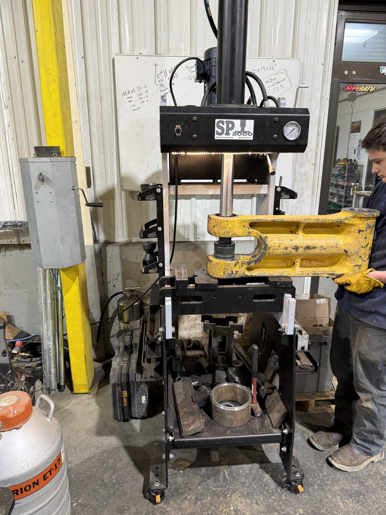 Hydraulic press machine in industrial workshop setting.