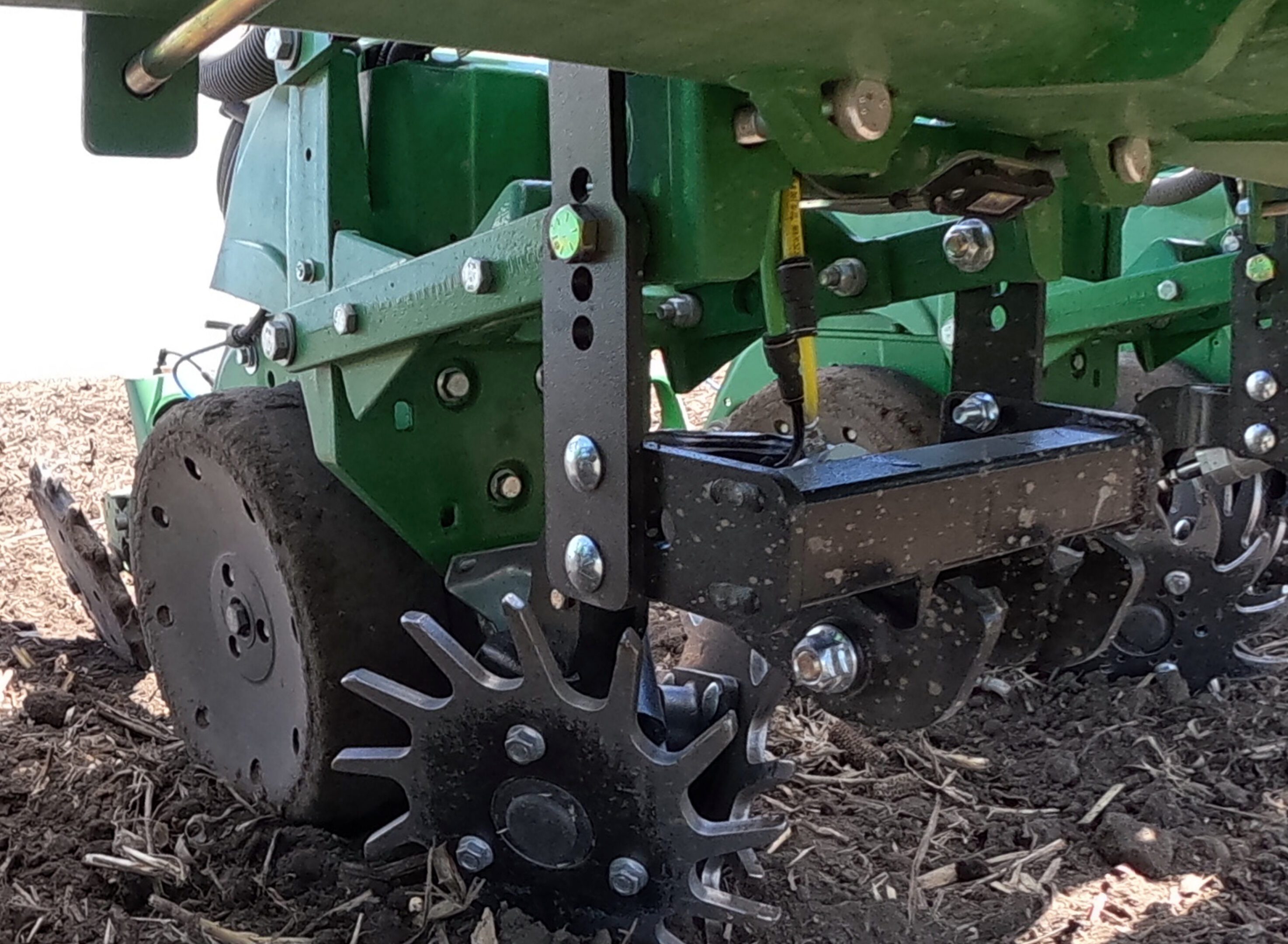 Close-up of agricultural machinery on soil.