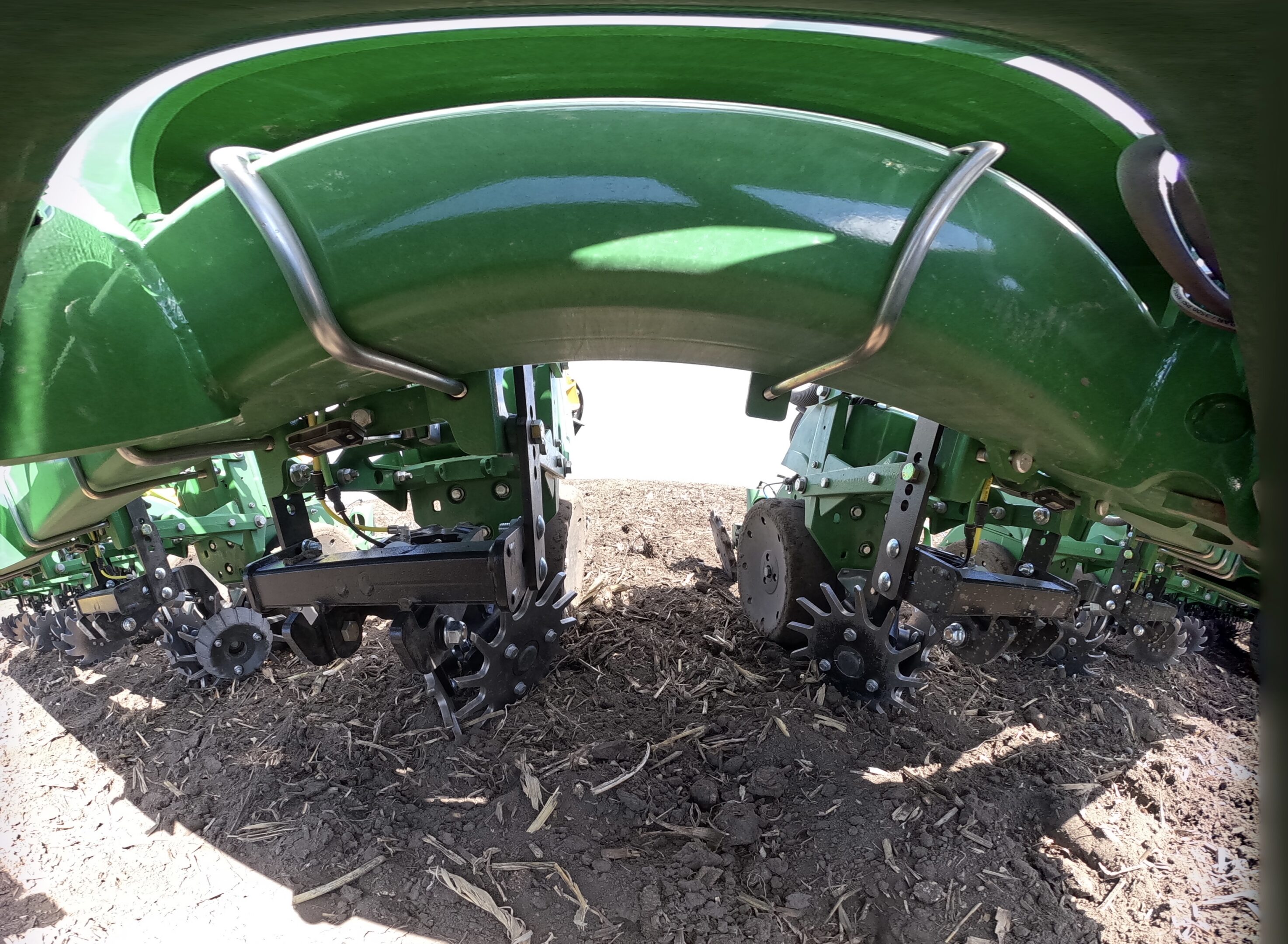 Agricultural machinery close-up on soil surface.