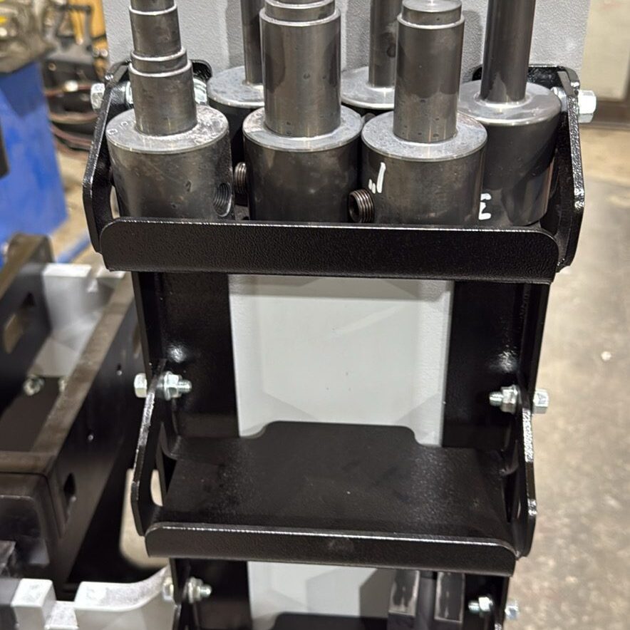 Machine component with metal cylinders and bolts.
