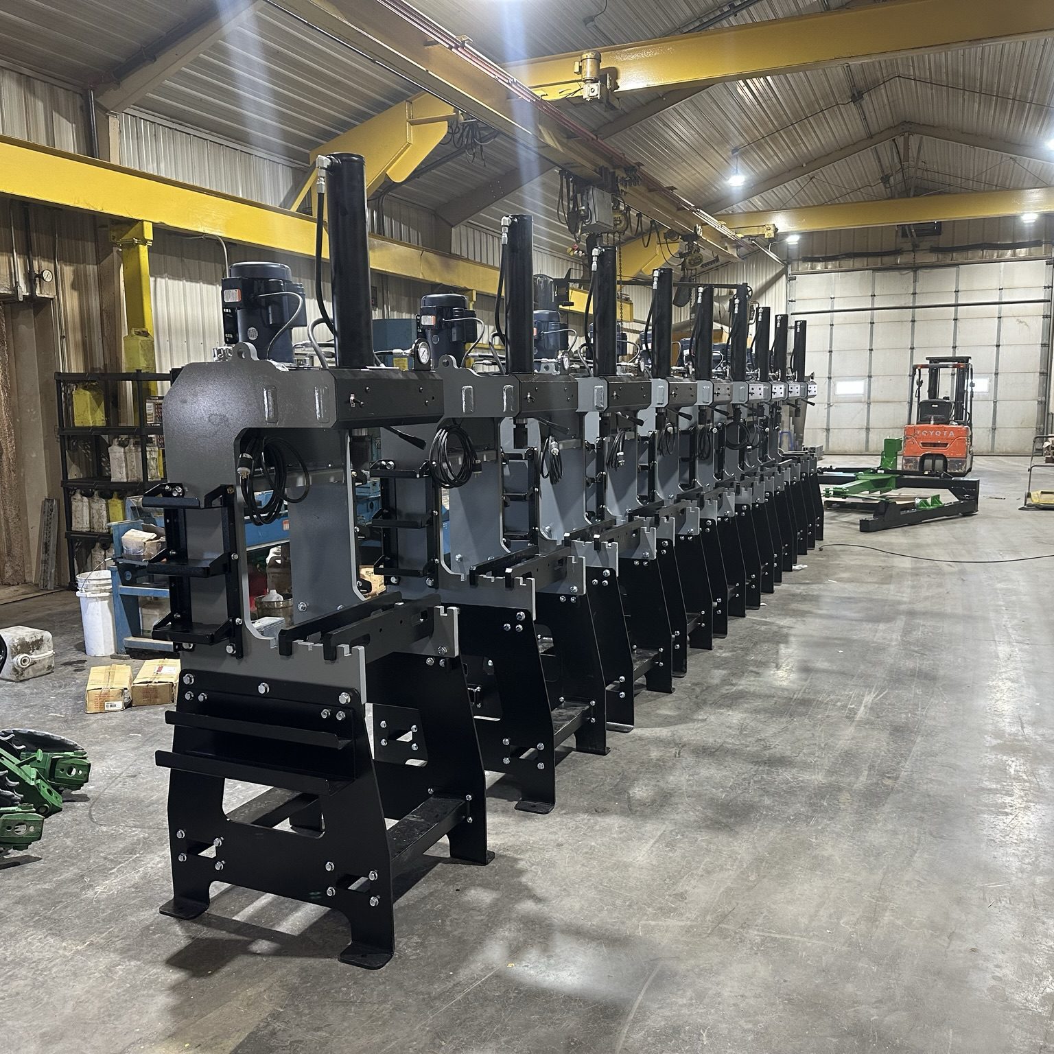 Row of industrial machines in a warehouse.